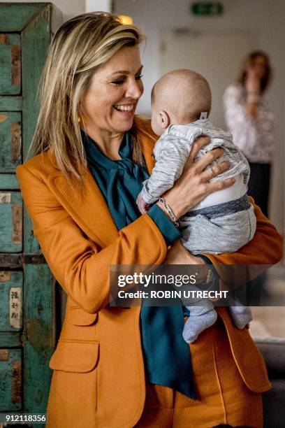 Dutch Queen Maxima holds a baby as she visits the Babyhuis in Dordrecht, on January 30, 2018. The foundation Babyhuis offers care and shelter for new...