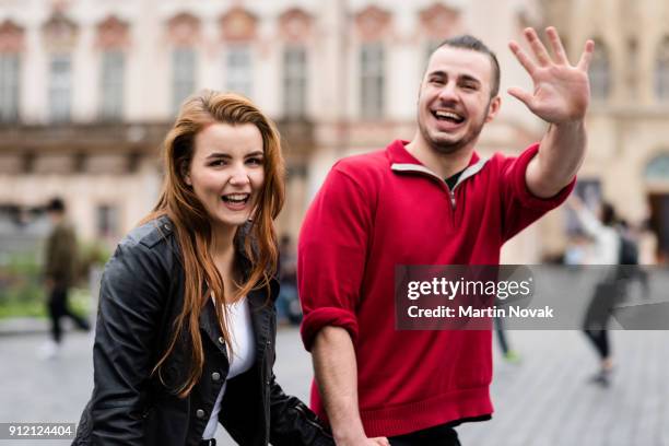 smiling man waving his hand at camera - introducing girlfriend stock pictures, royalty-free photos & images