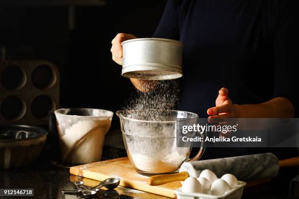 woman sifting flour through sieve. - sifting stock pictures, royalty-free photos & images