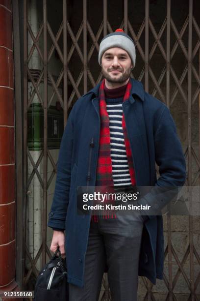 Presenter and Actor Stephen Kelly wears vintage trousers, Steig Lorgan bag, Norse Projects sweater, YMC jacket and hat and a Lochmeir scarf day 3 of...