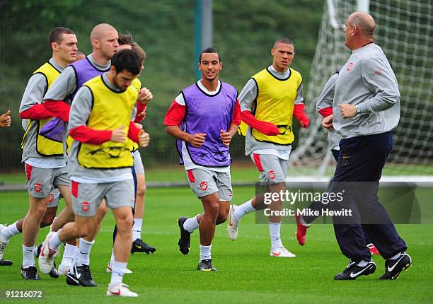 Theo Walcott of Arsenal warms up during a training session in preparation for tomorrow's Champions League Group H match against Olympiacos at London...