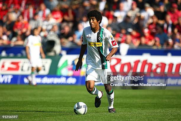 Dante Bonfim of M'gladbach runs with the ball during the Bundesliga match between SC Freiburg and Borussia M'gladbach at Badenova Stadium. On...