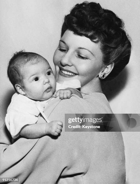 American actress and singer Mary Martin with her five-week old baby daughter Mary Heller Halliday, December 1941. Heller's father is producer Richard...