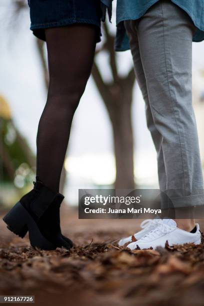 the foreground of the legs of a couple of boyfriends. - foot kiss stock pictures, royalty-free photos & images