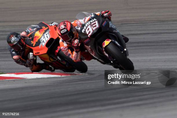 Marc Marquez of Spain and Repsol Honda Team leads Mika Kallio of Finland and Red Bull KTM Factory Racing during the MotoGP test in Sepang at Sepang...