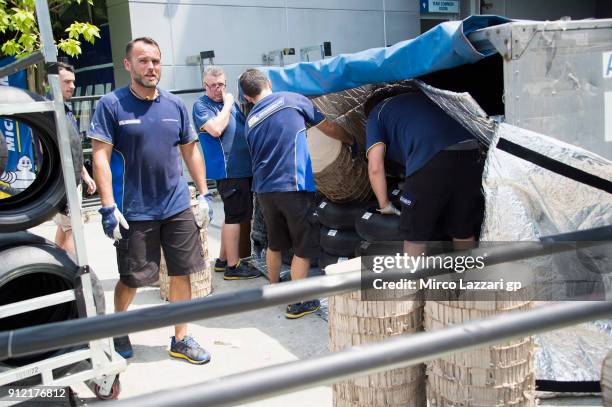 Michelin staff at work in the pit in order to organize the crates for traveling in Thailand during the MotoGP test in Sepang at Sepang Circuit on...