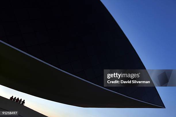 Visitors watch the sunset from the Oscar Niemeyer Museum, the largest museum in Latin America, on August 15, 2009 in Curitiba, the capital city of...