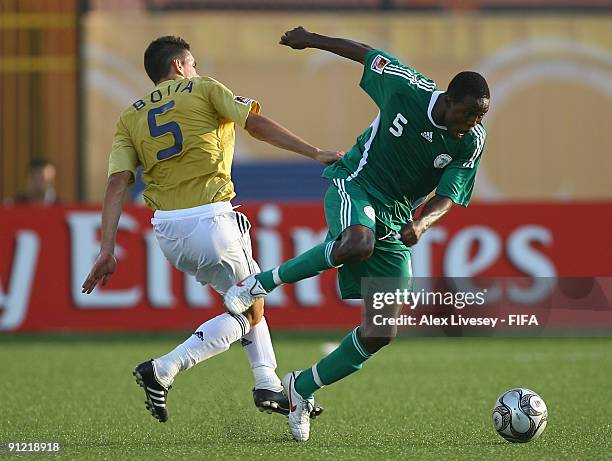 Raheem Lawal of Nigeria beats Alberto Botia of Spain during the FIFA U20 World Cup Group B match between Nigeria and Spain at the Al Salam Stadium on...