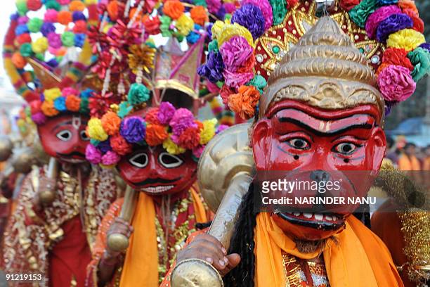 An Indian Hindu dressed as the ape god Hanuman takes part in a religious procession in the grounds of the Durgiana temple in Amritsar on September...