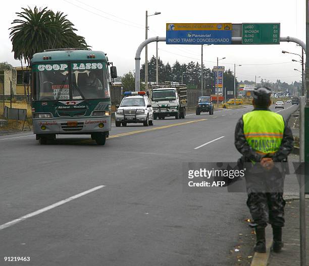 Policeman stands guard at the South Pan American Highway in Latacunga, 100 km south of Quito, wich remained unblocked and absolutely calm despite the...