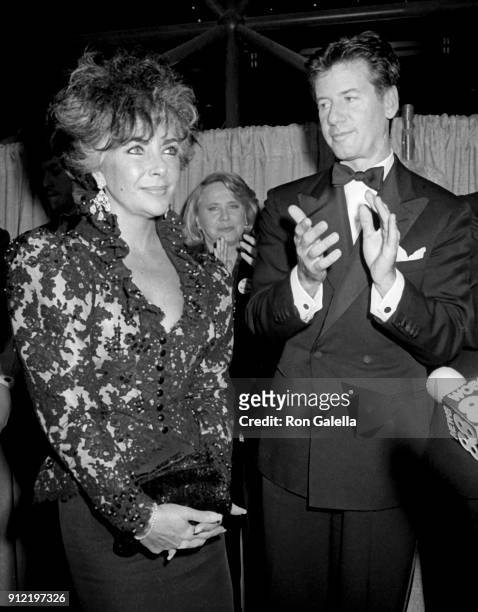 Elizabeth Taylor and Calvin Klein attend The World's Largest Photo Session Benefit for AIDS Research Foundation on April 29, 1986 at the Jacob Javits...