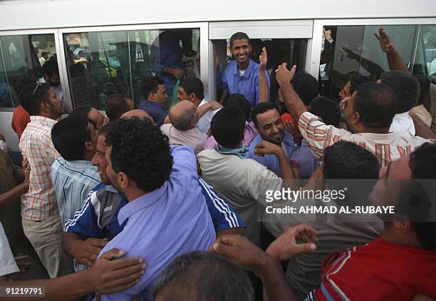 Relatives gather to meet released prisoners arriving on bus on September 28 in Baghdad after being freed from jail. Thirty two men were released...