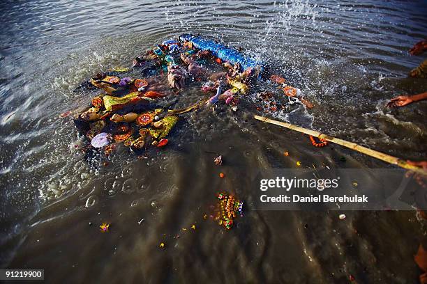 An idol of Hindu goddess Durga is immersed in the River Ganges on the last day of the Durga Puja festival on September 28, 2009 in Kolkata, India....