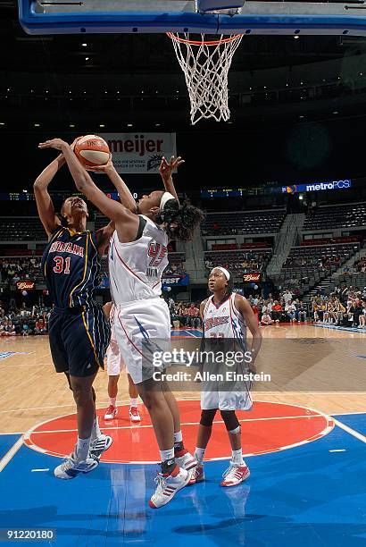 Jessica Moore of the Indiana Fever put up a shot against Kara Braxton of the Detroit Shock during Game One of the WNBA Eastern Conference Finals at...