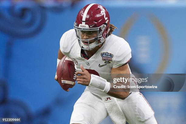 Alabama Crimson Tide quarterback Jalen Hurts runs with the football during the College Football Playoff Semifinal at the Allstate Sugar Bowl between...