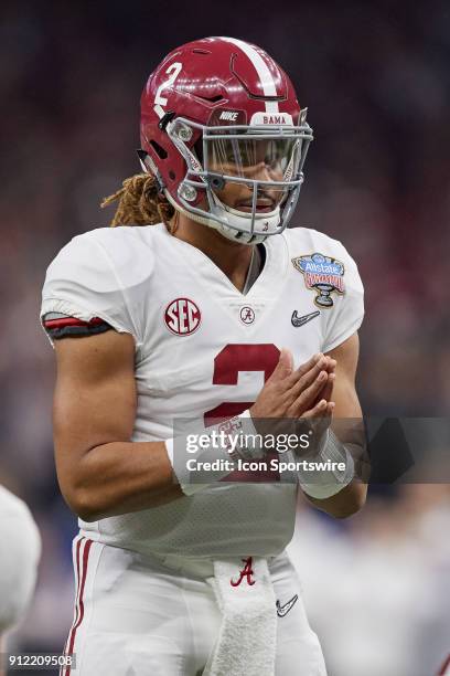 Alabama Crimson Tide quarterback Jalen Hurts claps his hands before snapping for the football during the College Football Playoff Semifinal at the...