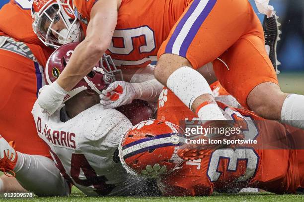 Alabama Crimson Tide running back Damien Harris is tackled by Clemson Tigers linebacker J.D. Davis and Clemson Tigers safety Tanner Muse during the...