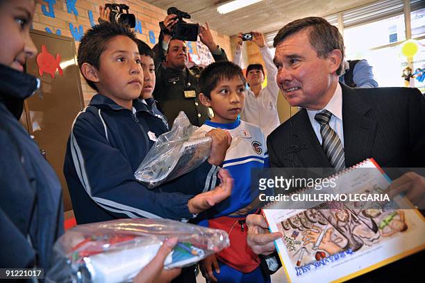 Director of the Office of National Drug Control Policy Gil Kerlikowske is greeted by schoolchildren during a visit to a school in Bogota, Colombia,...