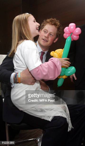 Prince Harry meets eight year old Lucy Tutton, winner of the Most Caring Child Award, at the WellChild Awards on September 28, 2009 in London,...