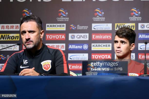 Vitor Pereira, head coach of Shanghai SIPG, and player Oscar attend a press conference after the 2018 AFC Champions League qualifying match between...