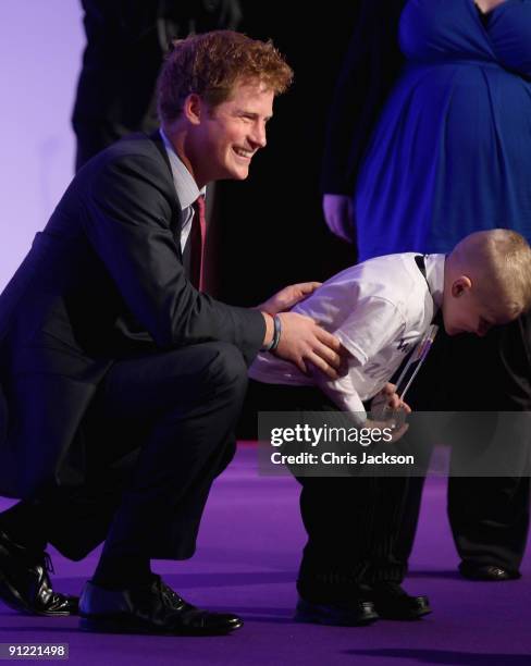 Alex Burke, aged six, bows as Prince Harry presents him with the Bravery Award during the WellChild Awards at the Intercontinental Hotel on September...