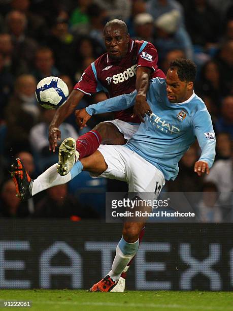 Carlton Cole of West Ham United tangles with Joleon Lescott of Manchester City during the Barclays Premier League match between Manchester City and...