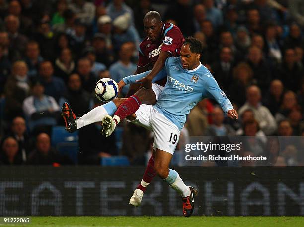 Carlton Cole of West Ham United tangles with Joleon Lescott of Manchester City during the Barclays Premier League match between Manchester City and...