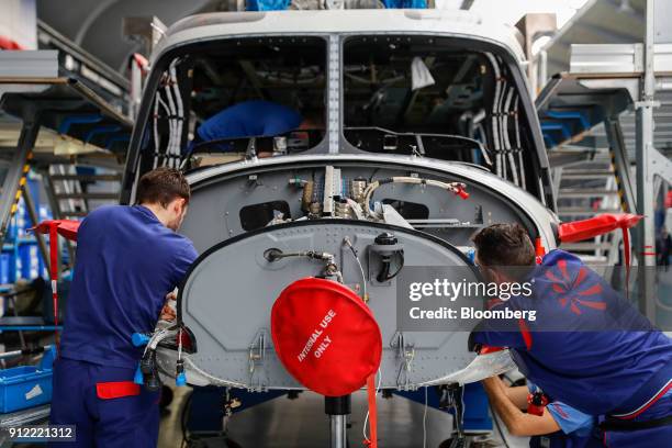 Employees work on AgustaWestland AW189 helicopter at a Leonardo SpA plant in Vergiate, Italy, on Tuesday, Jan. 30, 2018. Leonardo said it will stick...