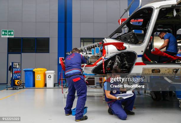 Employees work on AgustaWestland AW189 helicopter at a Leonardo SpA plant in Vergiate, Italy, on Tuesday, Jan. 30, 2018. Leonardo said it will stick...