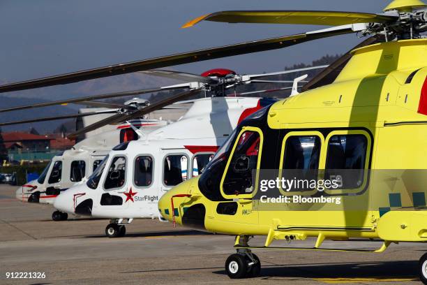 Helicopters stand displayed on the tarmac during an investor day at a Leonardo SpA plant in Vergiate, Italy, on Tuesday, Jan. 30, 2018. Leonardo said...