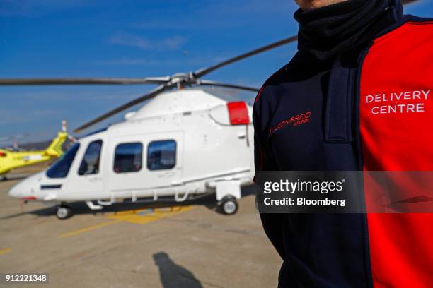 An employee stands next to an AgustaWestland AW109 helicopter at a Leonardo SpA plant in Vergiate, Italy, on Tuesday, Jan. 30, 2018. Leonardo said it...