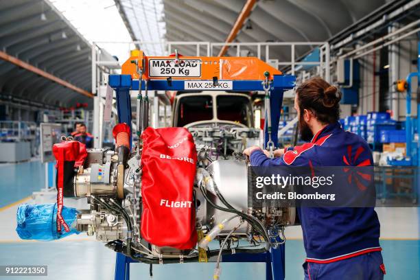 An employee works on a 69068 Motor DX at a Leonardo SpA plant in Vergiate, Italy, on Tuesday, Jan. 30, 2018. Leonardo said it will stick to a...