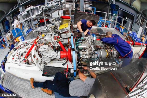 Employees work on AgustaWestland AW189 helicopter at a Leonardo SpA plant in Vergiate, Italy, on Tuesday, Jan. 30, 2018. Leonardo said it will stick...