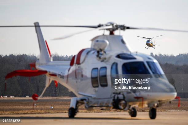 Helicopter lands behind an AgustaWestland AW109 helicopter at a Leonardo SpA plant in Vergiate, Italy, on Tuesday, Jan. 30, 2018. Leonardo said it...