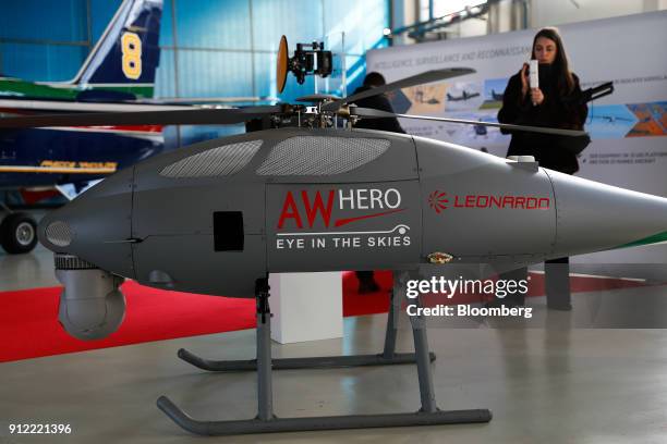 An attendee looks at an AW Hero Unmanned Aircraft System during an investor day at a Leonardo SpA plant in Vergiate, Italy, on Tuesday, Jan. 30,...