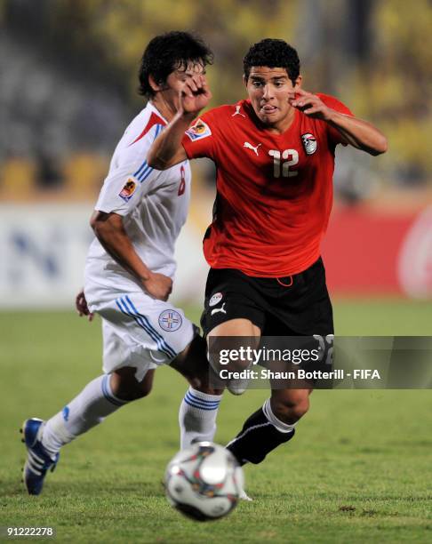 Islam Ramadan of Egypt is challenged by Hernan Perez of Paraguay during the FIFA U20 World Cup Group A match between Egypt and Paraguay at the Cairo...