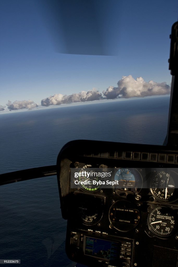 Dashboard of a helicopter flying over an ocean