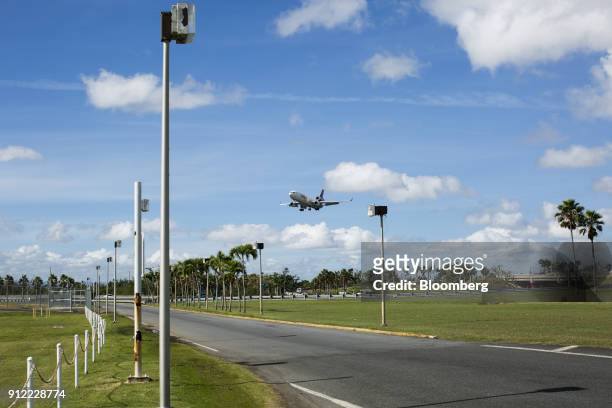 An airplane prepares for landing at Luis Munoz Marin International Airport in Carolina, Puerto Rico, on Sunday, Jan. 21, 2018. Before Hurricane Maria...
