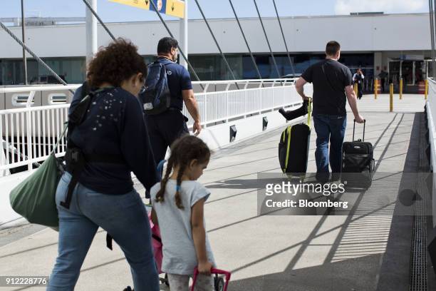 Travelers arrive at Luis Munoz Marin International Airport in Carolina, Puerto Rico, on Sunday, Jan. 21, 2018. Before Hurricane Maria struck four...