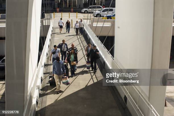 Travelers arrive at Luis Munoz Marin International Airport in Carolina, Puerto Rico, on Sunday, Jan. 21, 2018. Before Hurricane Maria struck four...