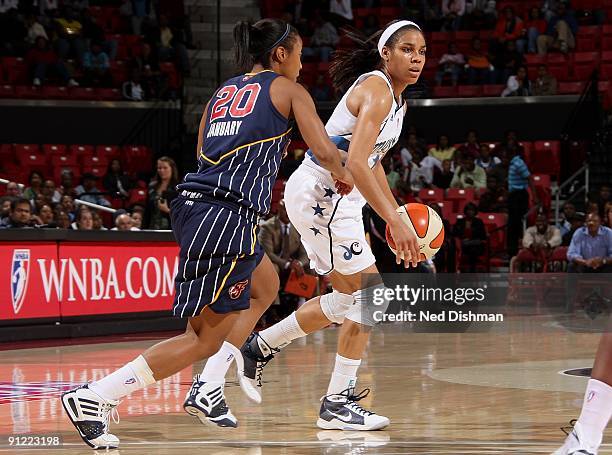 Lindsey Harding of the Washington Mystics drives the ball against Briann January of the Indiana Fever during Game One of the WNBA Eastern Conference...