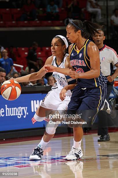 Lindsey Harding of the Washington Mystics drives the ball against Briann January of the Indiana Fever during Game One of the WNBA Eastern Conference...