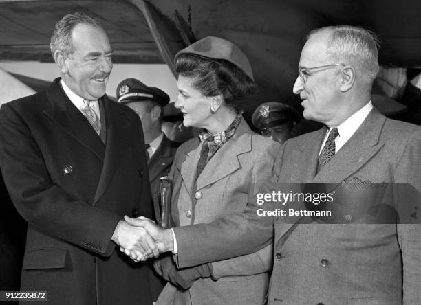 Secretary of State, Dean Acheson, is greeted by Mrs. Acheson and President Truman as he arrived at Washington Airport from Europe.