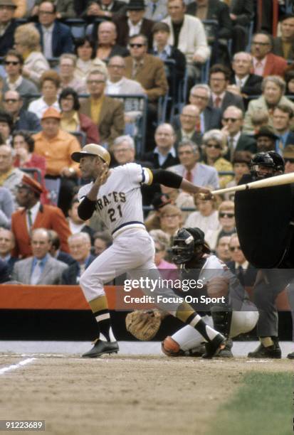 Outfielders Roberto Clemente of the Pittsburgh Pirtates swings and watches the flight of his ball against the Baltimore Orioles during the World...