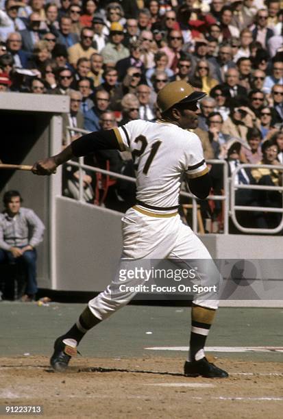 S: Outfielder Roberto Clemente Pittsburgh Pirates swings and watches the flight of his ball during a MLB baseball game circa early 1970's at Three...