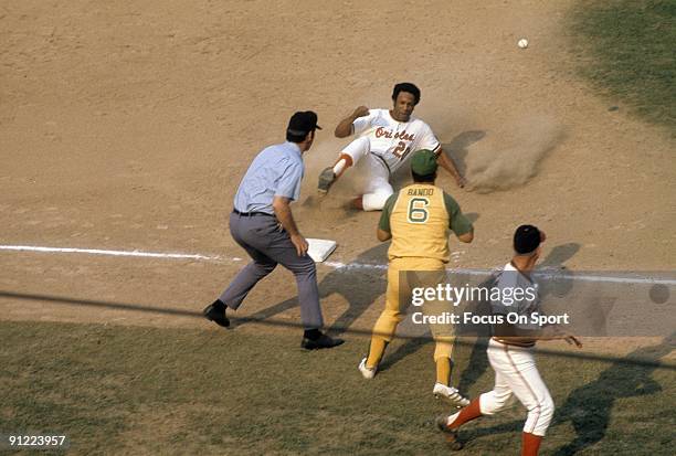 S: Outfielder Frank Robinson of the Baltimore Orioles in action sliding safe into third base against the Oakland Athletics during a circa early...