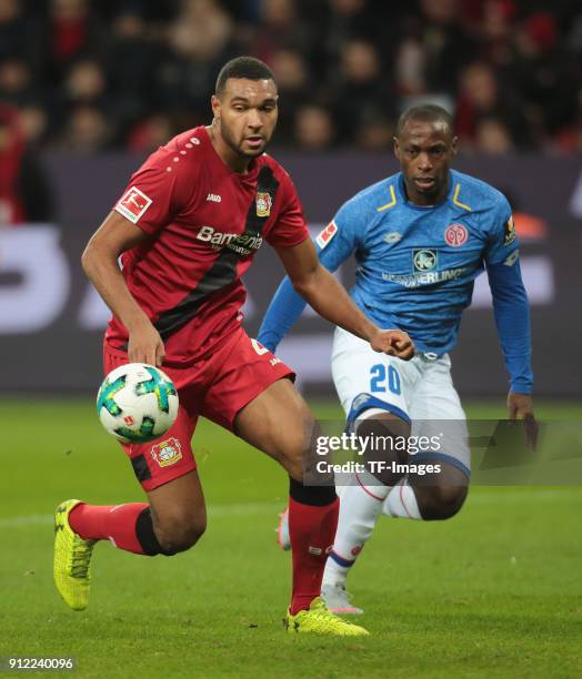 Jonathan Tah of Leverkusen and Anthony Ujah of Mainz battle for the ball during the Bundesliga match between Bayer 04 Leverkusen and 1. FSV Mainz 05...