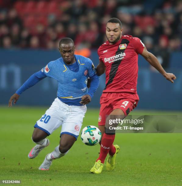 Jonathan Tah of Leverkusen and Anthony Ujah of Mainz battle for the ball during the Bundesliga match between Bayer 04 Leverkusen and 1. FSV Mainz 05...