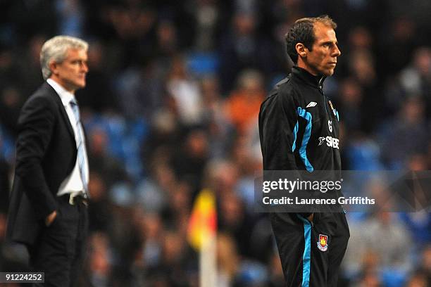 Manchester City Manager Mark Hughes and West Ham United Manager Gianfranco Zola watch the action during the Barclays Premier League match between...