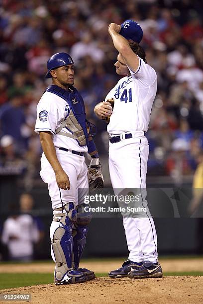 Pitcher Lenny DiNardo and catcher Miguel Olivo of the Kansas City Royals confer on the mound during a break in game action against the Boston Red Sox...